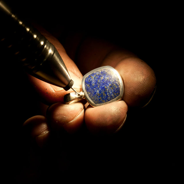 An atmospheric making of image of a signet necklace with lapis lazuli