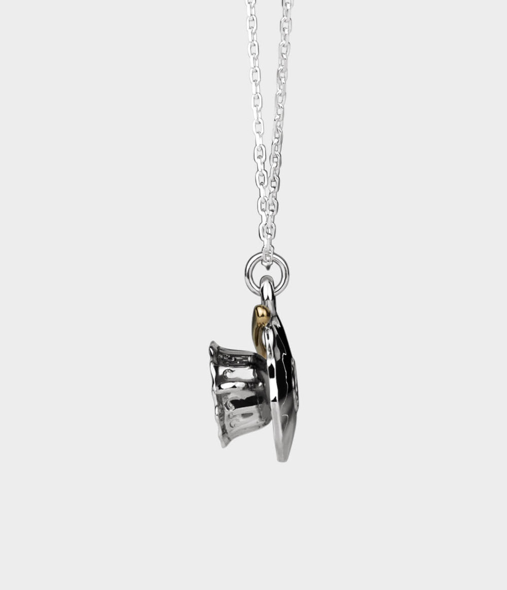 side view of a silver and gold teacup charm on a necklace.