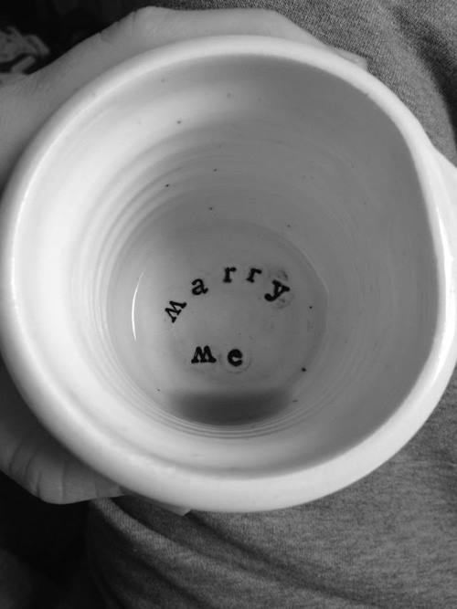 Paper cup with the words Marry Me printed at the bottom, in black and white