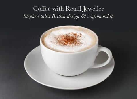 Cappuccino in a white cup and saucer, captioned Coffee with Retail Jeweller, Stephen talks British design
