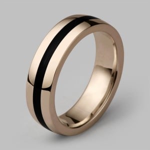 Rose gold wedding band with a black enamel stripe running around its centre