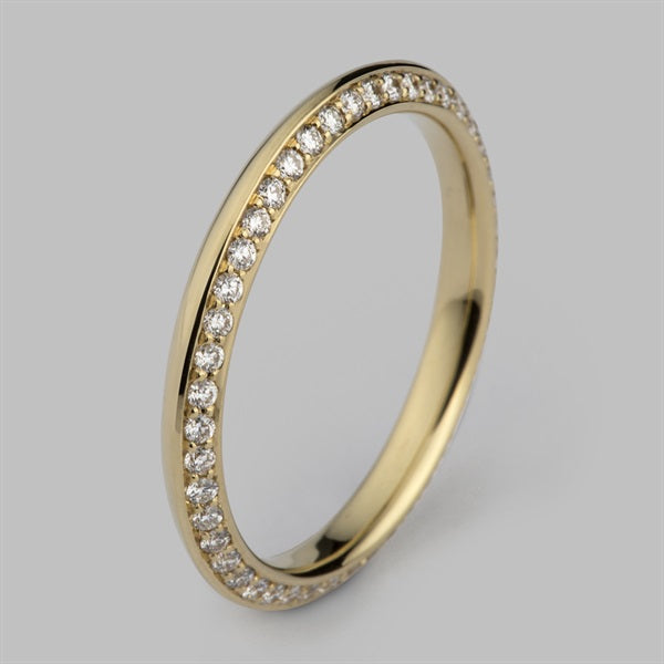 Yellow gold eternity ring set with a full row of small round diamonds