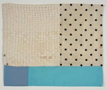 Fabric artwork of woven cream strips beside black polka dot cloth above two blue panels