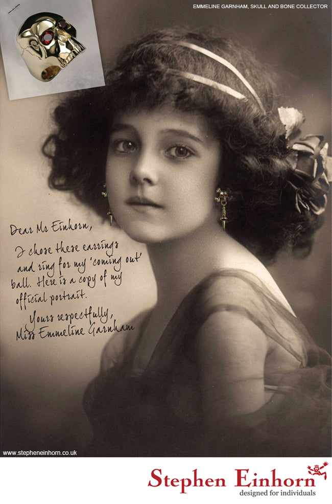 Vintage-style portrait of a girl in skull drop earrings, with an inset gold skull ring with red stone eyes