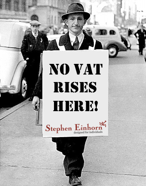Vintage street photo of a man wearing a sandwich board reading 'No VAT rises here!' with the Stephen Einhorn logo