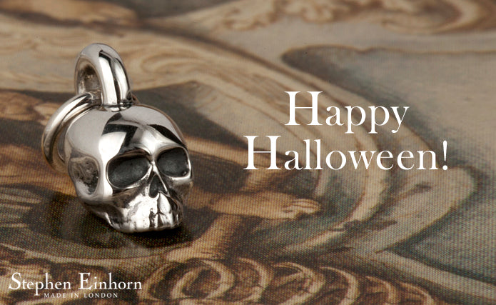 Polished silver skull pendant on a bail beside the words Happy Halloween