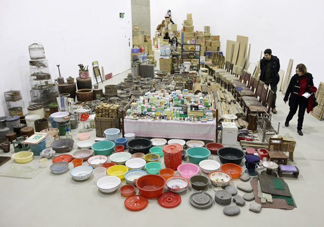 Song Dong's Waste Not installation: household bowls, bottles and boxes laid out across a gallery floor