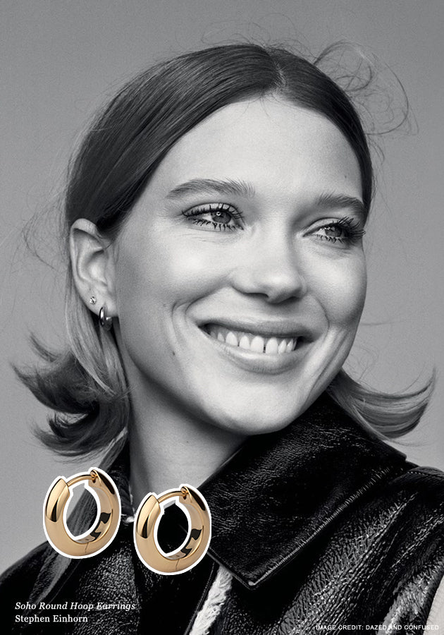 Black and white portrait of a smiling woman wearing small hoops, with the gold Soho Round Hoop Earrings inset