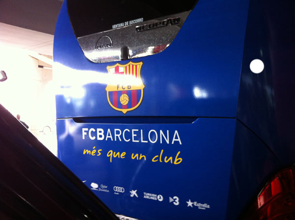 Back of the FC Barcelona team coach with the club crest and 'més que un club' slogan