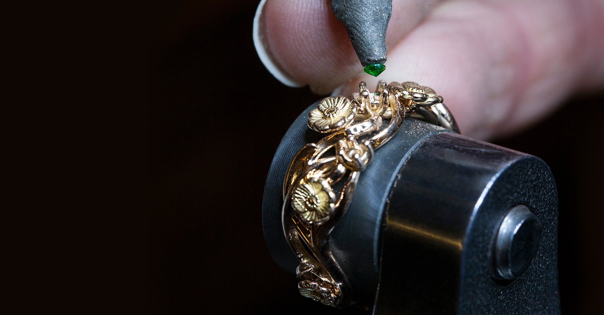 Jeweller handcrafting a bespoke emerald and diamond halo ring at Stephen Einhorn's London workshop