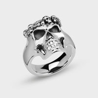 Silver crowned skull ring on a light gray background