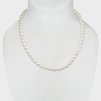 Irregular shaped ‘rice’ white pearl necklace with silver clasp.