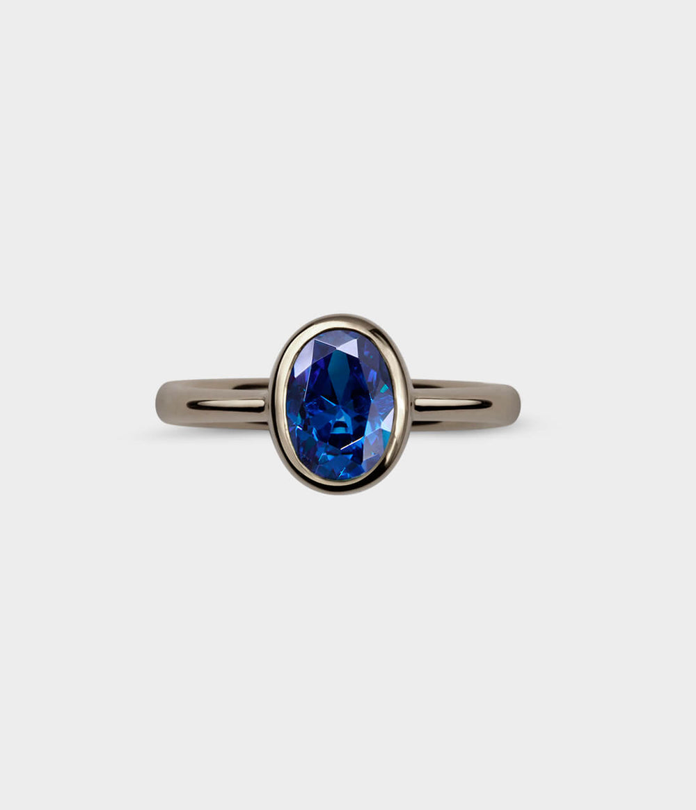 Oval Halo Ring in 18ct White Gold with Blue Sapphires, Size J1/2