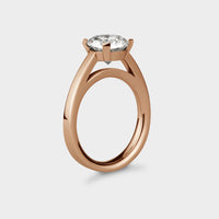 front view of a 2 carat rdiant light ring in yellow gold with a black sapphire.