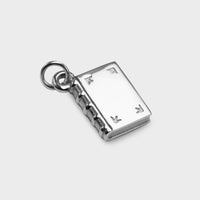 a close up of a silver Book Charm