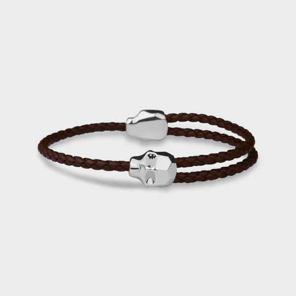 Two carved angular sterling silver skulls on an adjustable leather bracelet by Stephen Einhorn