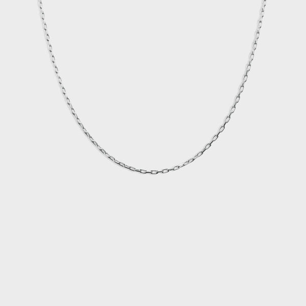 a silver charm necklace close up