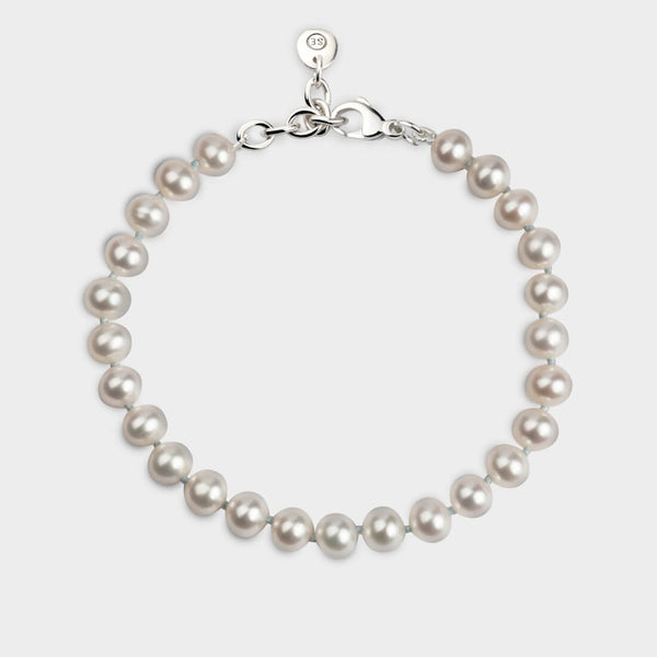 ariel view of a white pearl bracelet with a sterling silver chain.