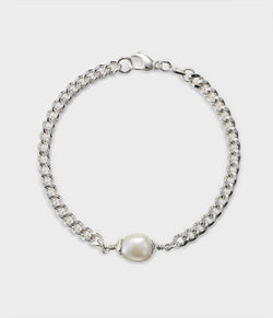 an overview of a chain and baroque pearl bracelet with a white pearl