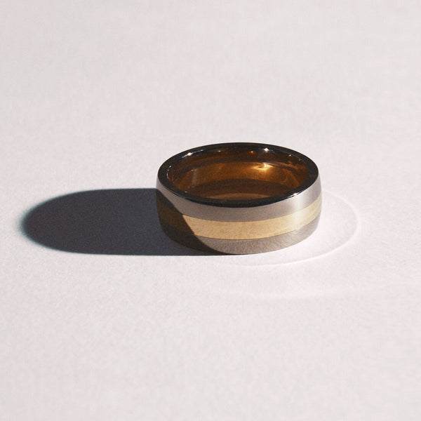 Metal Geo Ellipse Slim Ring laying flat creating a dark shadow