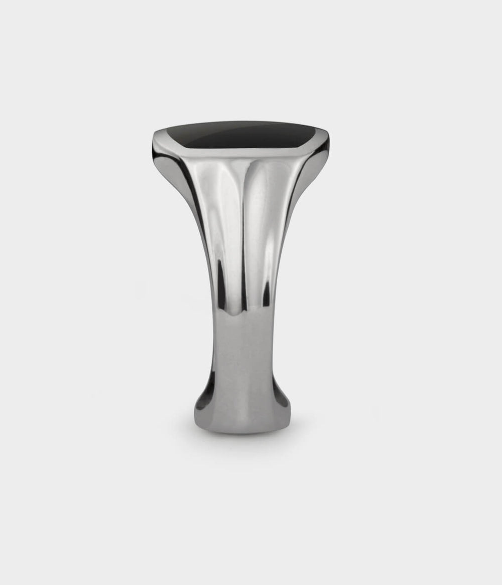 a close up side profile of a silver and onyx signet ring.