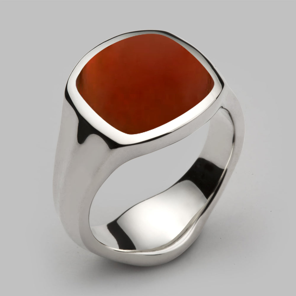 A solid silver signet ring with inlaid cornelian