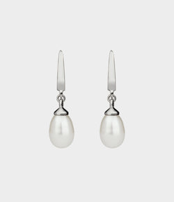 a pair of white freshwater pearl drop earrings with silver clips.