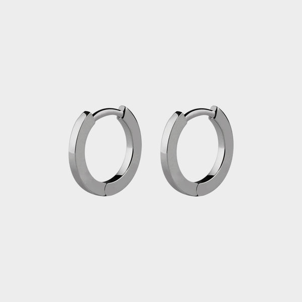 a close up of platinum mini small hoops