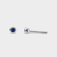 front and side view of muni halo studs in silver with blue sapphires
