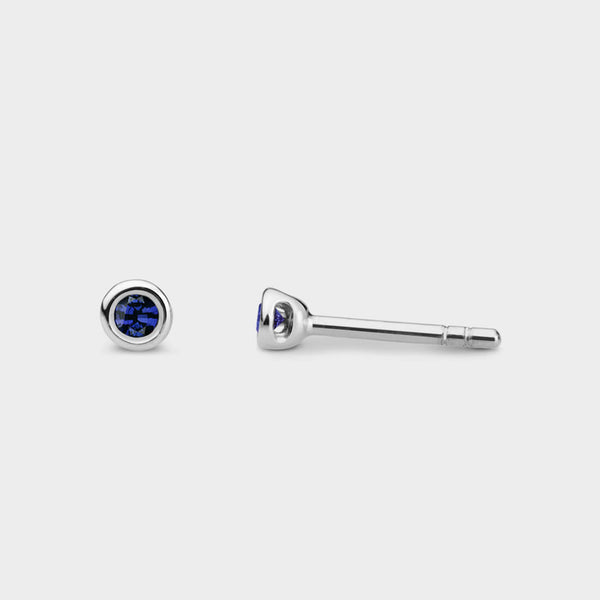 front and side view of muni halo studs in silver with blue sapphires