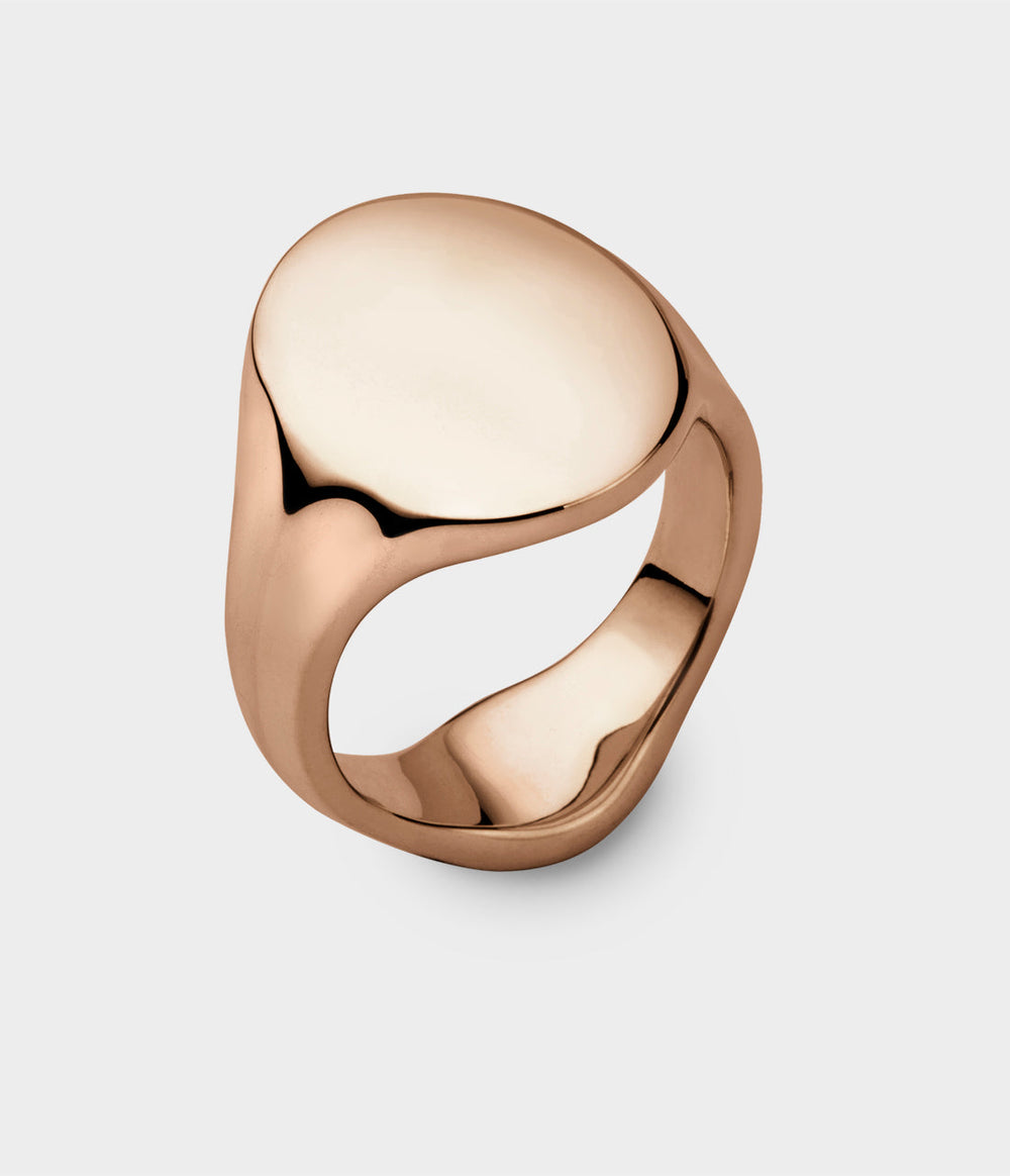 close up of a rose gold solid oval signet ring