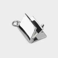 a close up of a silver Opening Book Charm