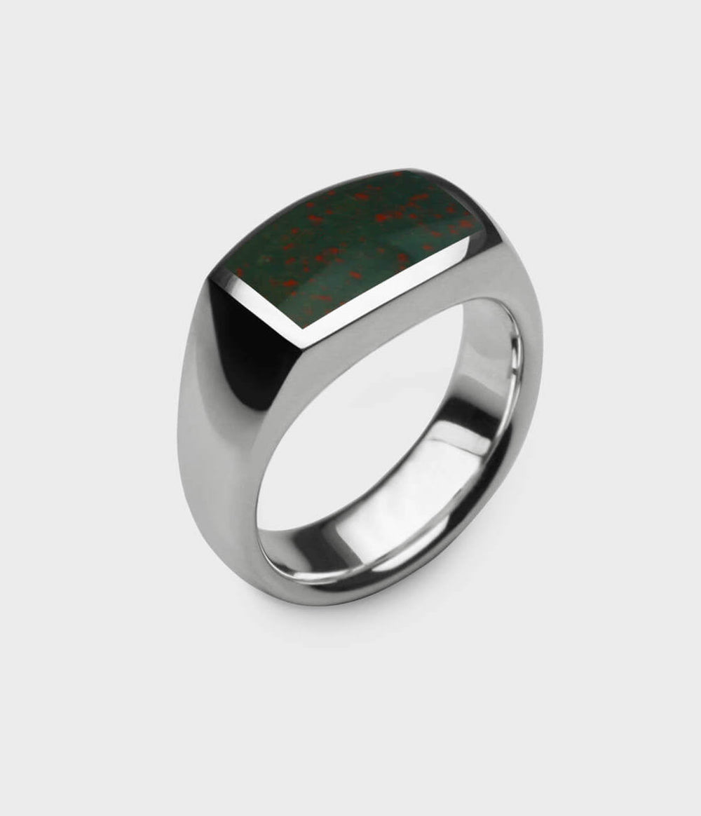 a side view of a silver oxford ring inlaid with bloodstone.