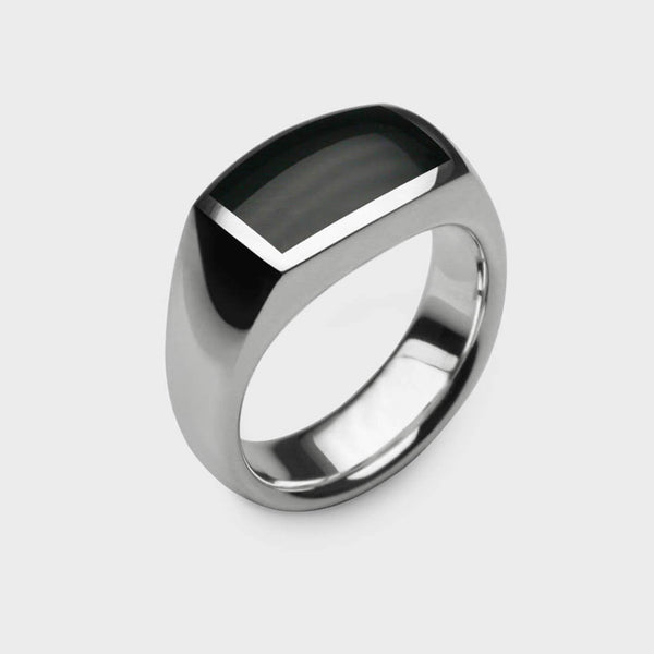 close up of A silver and black onyx signet ring