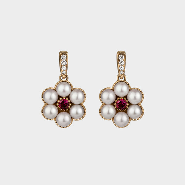 6 pearl drop earrings set with a central round ruby on a yellow gold and diamond clip.
