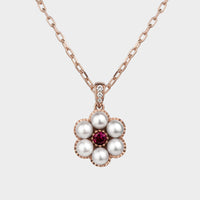 close up of the posy pearl gold and ruby necklace.
