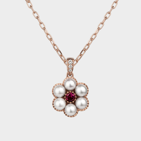 close up of the posy pearl gold and ruby necklace.
