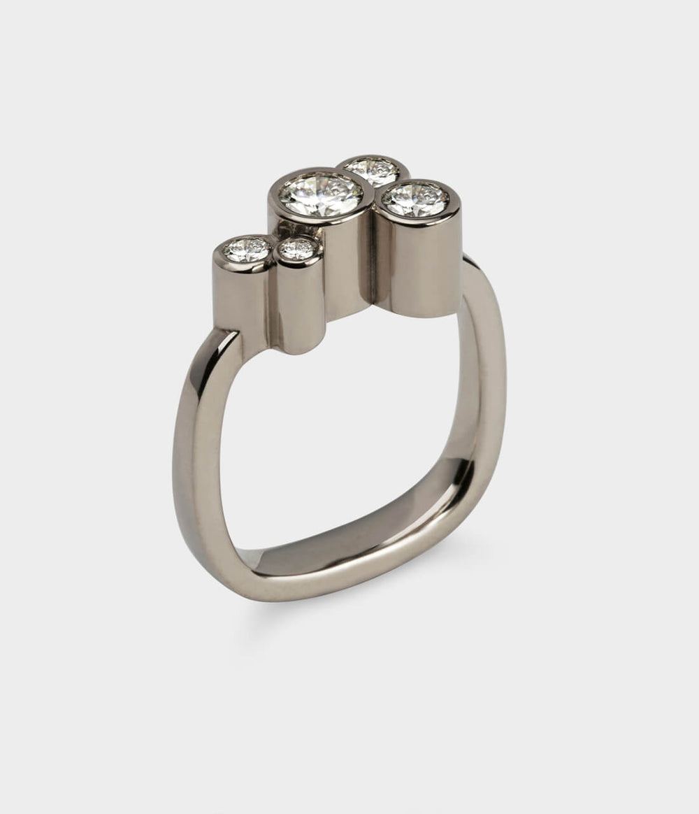 a close up of the roudhaus ring in white gold with diamonds.