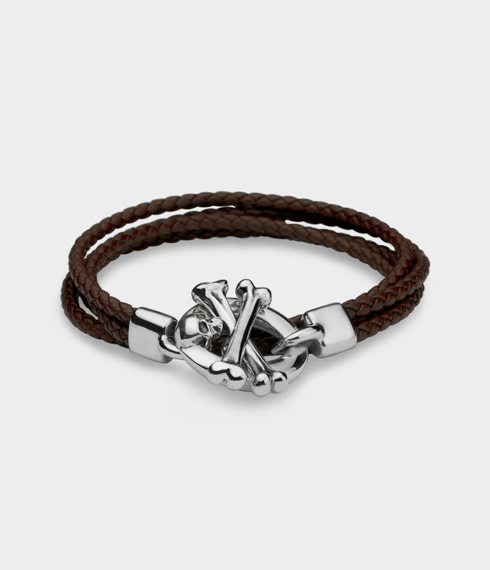 A brown leather double strand  bracelet with a detailed silver skull and crossbone T bar catch.