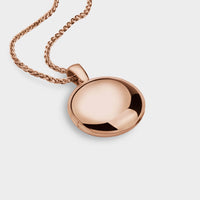 a close up of a rose gold touch locket.